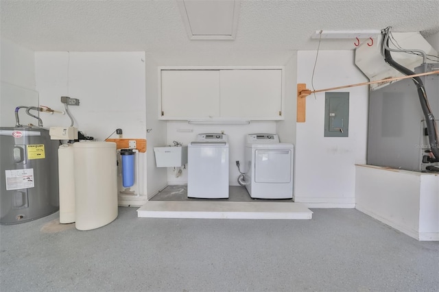 laundry room featuring a textured ceiling, sink, washing machine and dryer, and electric water heater