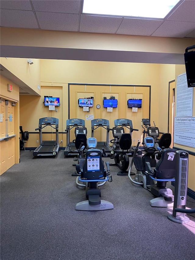 workout area featuring a drop ceiling and carpet floors