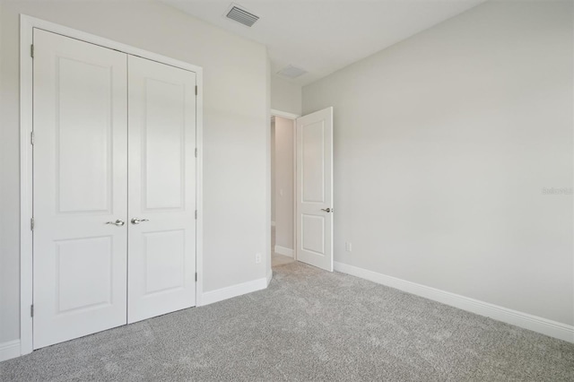 unfurnished bedroom with carpet and a closet