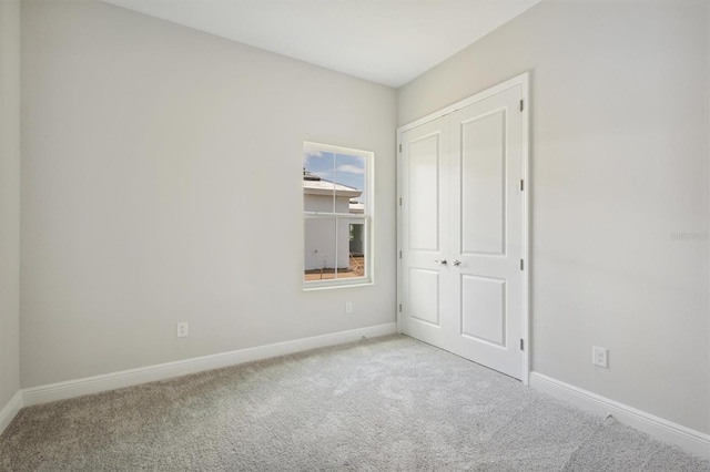 spare room featuring light carpet