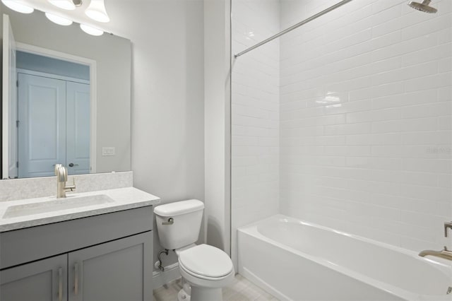 full bathroom featuring vanity, tiled shower / bath combo, and toilet