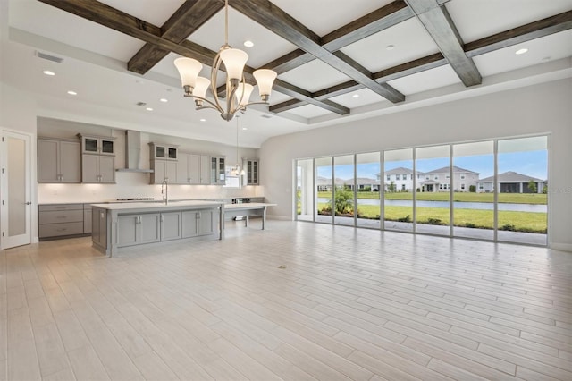 unfurnished living room featuring light wood-type flooring and coffered ceiling