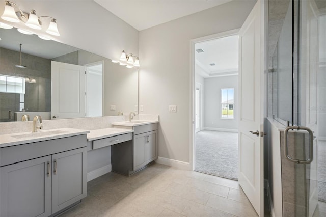 bathroom with baseboards, double vanity, a sink, and a shower stall