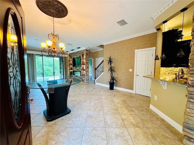 interior space featuring decorative light fixtures, an inviting chandelier, light tile floors, and light stone countertops