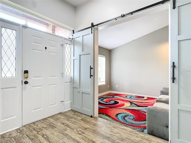 entryway with a barn door and light wood-type flooring