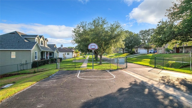 view of basketball court featuring a yard