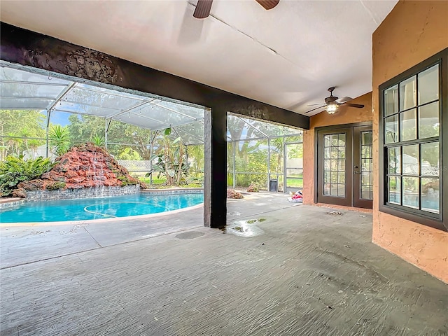 view of patio / terrace featuring pool water feature, ceiling fan, glass enclosure, and french doors