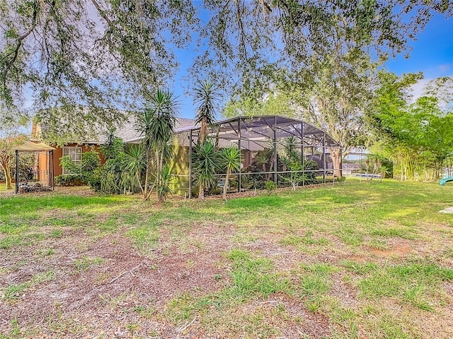 view of yard featuring glass enclosure