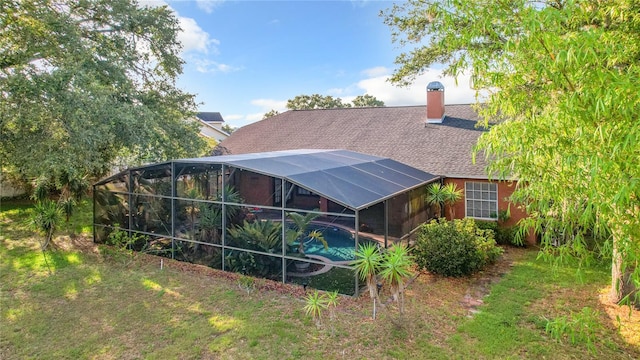 rear view of house featuring a lanai