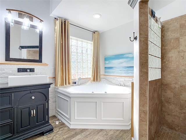 bathroom featuring hardwood / wood-style floors, vanity, and independent shower and bath