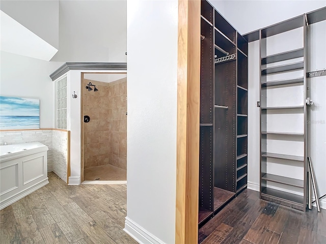 bathroom featuring hardwood / wood-style floors, separate shower and tub, and tile walls