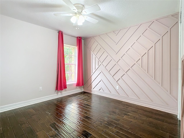 spare room featuring a textured ceiling, ceiling fan, and dark wood-type flooring