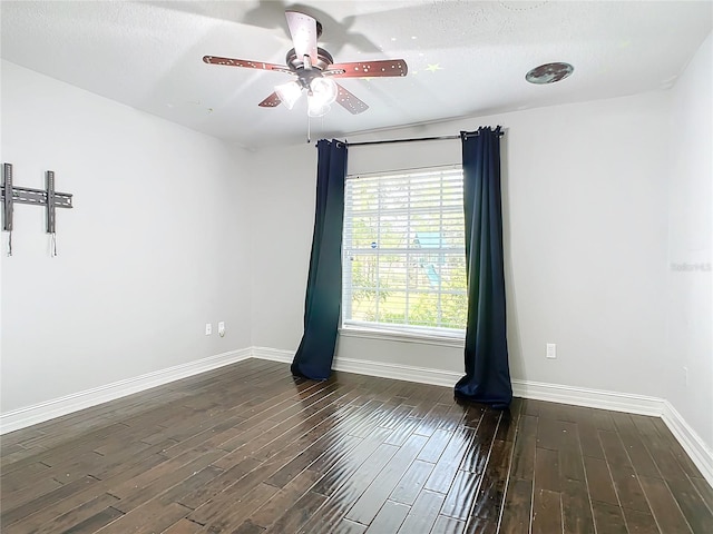 unfurnished room featuring a textured ceiling, ceiling fan, and dark wood-type flooring