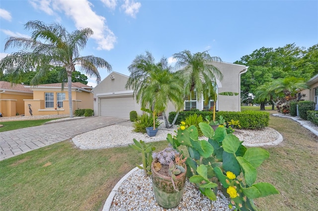 view of front of home with a garage and a front lawn