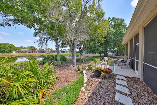 view of yard featuring a patio and a water view