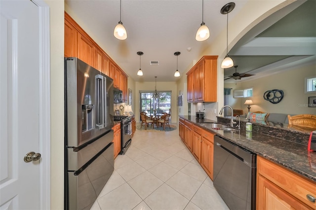 kitchen featuring hanging light fixtures, appliances with stainless steel finishes, sink, and ceiling fan