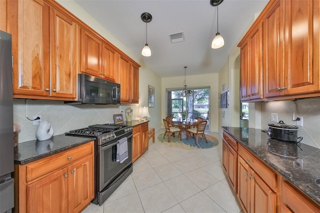 kitchen featuring dark stone countertops, black appliances, pendant lighting, tasteful backsplash, and light tile floors