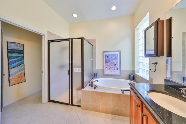 bathroom with shower with separate bathtub, tile floors, and large vanity