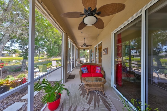 sunroom / solarium featuring ceiling fan and a healthy amount of sunlight