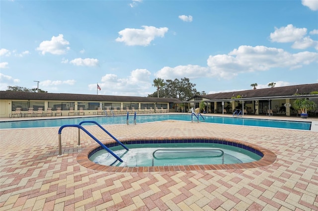 view of pool featuring a hot tub