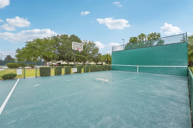 view of tennis court featuring basketball court