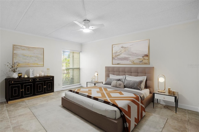 tiled bedroom featuring ceiling fan and a textured ceiling