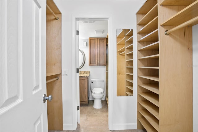 spacious closet featuring light tile floors