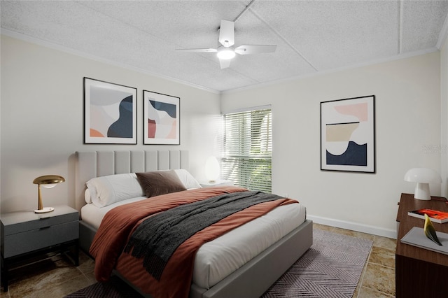 tiled bedroom with a textured ceiling, ceiling fan, and ornamental molding