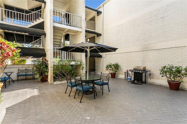 view of terrace featuring area for grilling and a balcony