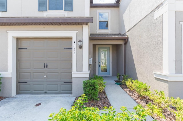 view of exterior entry with a garage