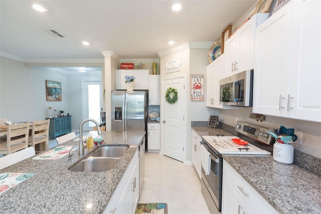 kitchen featuring white cabinets, crown molding, sink, light stone counters, and stainless steel appliances