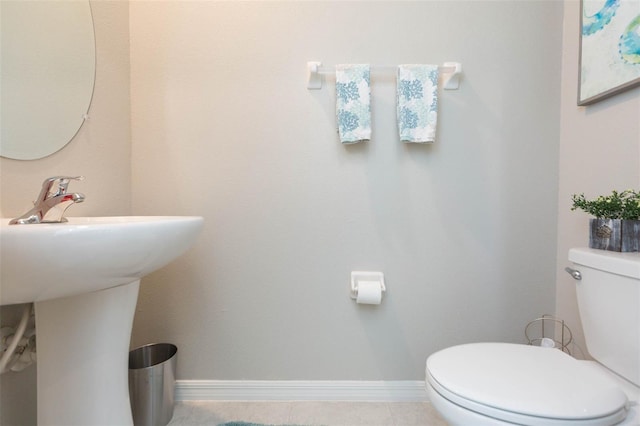 bathroom with tile patterned flooring and toilet