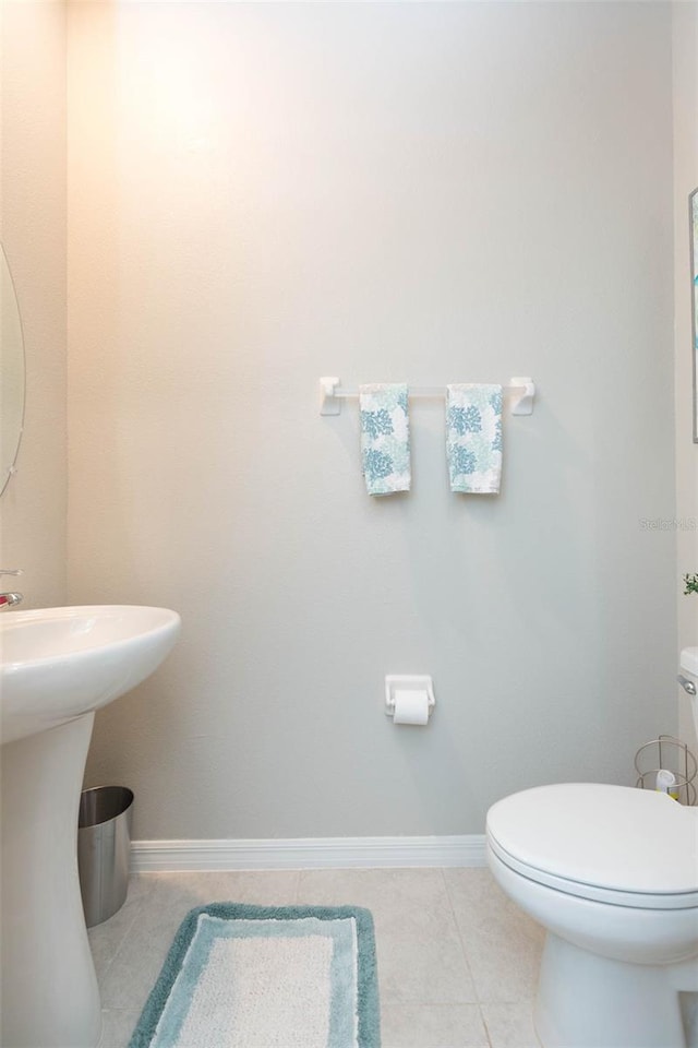 bathroom with sink, tile patterned flooring, and toilet