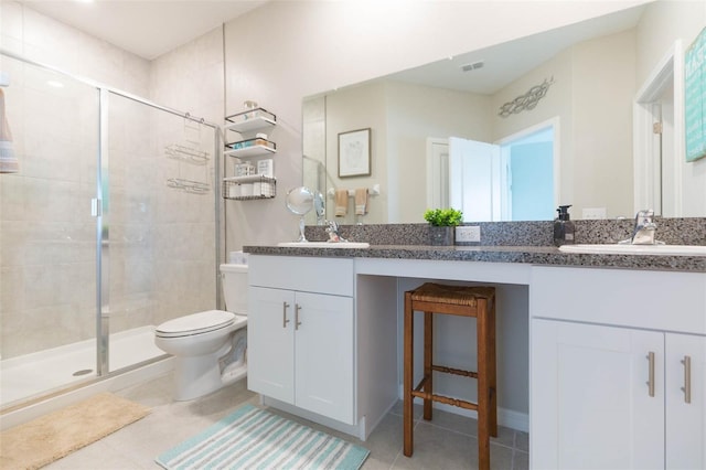 bathroom featuring tile patterned flooring, vanity, and a shower with door