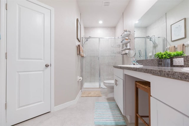 bathroom with vanity, an enclosed shower, and toilet