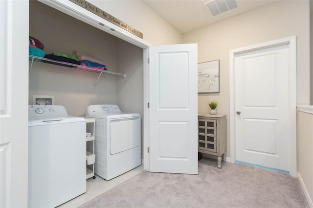 laundry room featuring light colored carpet and washing machine and clothes dryer