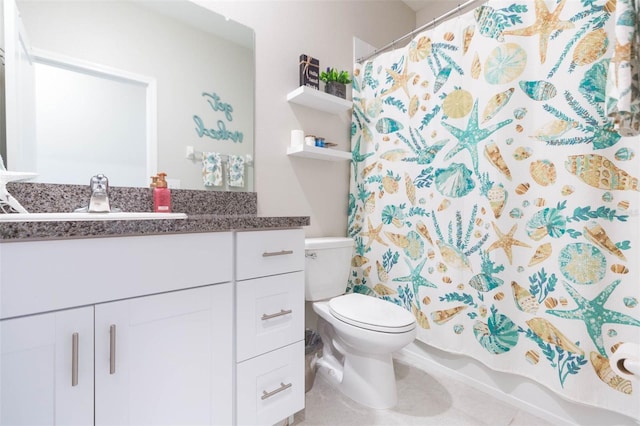 bathroom with tile patterned floors, vanity, and toilet