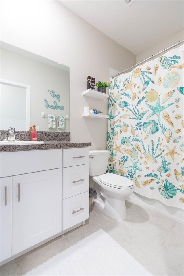 bathroom with toilet, a shower with curtain, vanity, and tile patterned floors