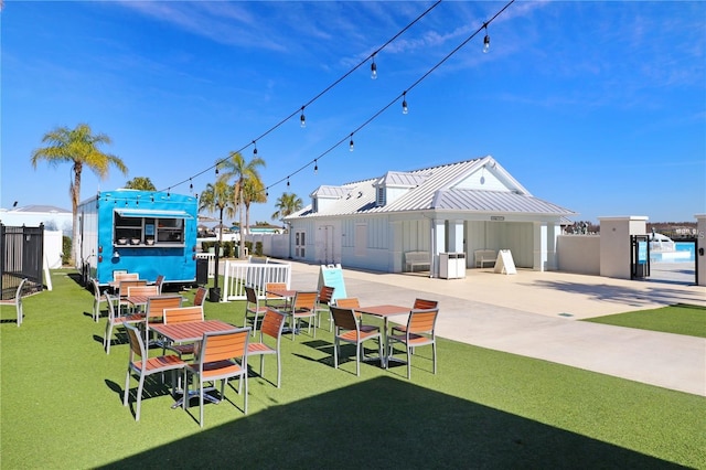 view of community with a lawn and a patio area