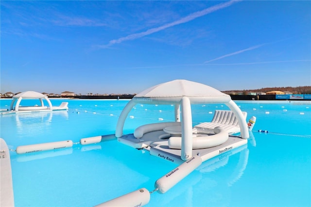 view of swimming pool with a water view