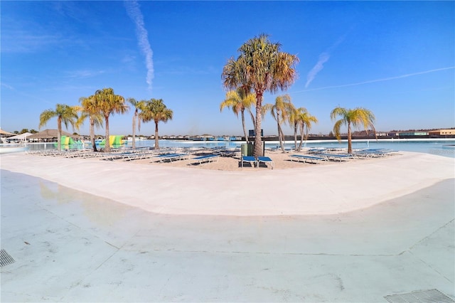 view of home's community featuring a water view and a beach view