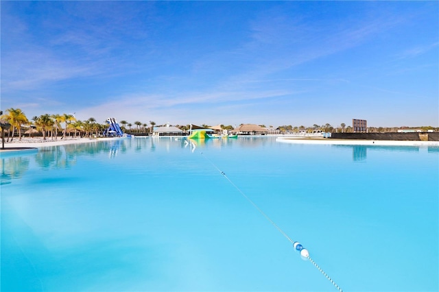 view of pool featuring a water view