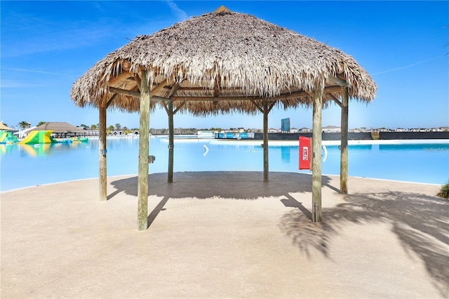 view of swimming pool featuring a gazebo and a water view