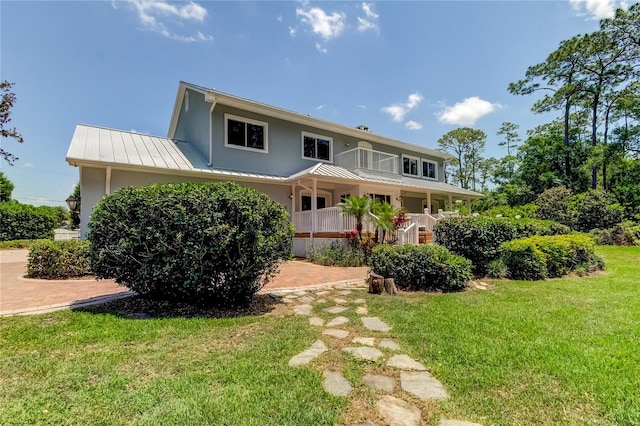 view of front of home featuring a front yard and a porch