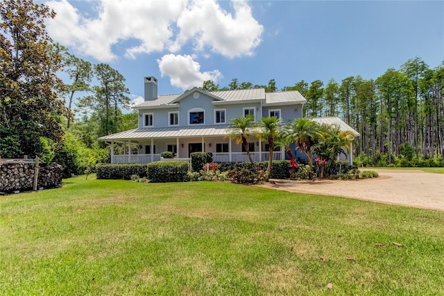 view of front facade with a front yard and covered porch