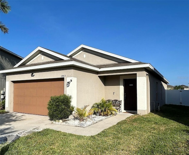 ranch-style house featuring a garage, a front yard, concrete driveway, and stucco siding