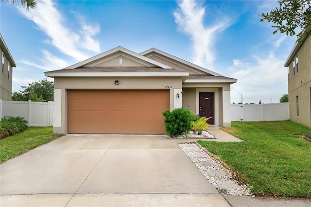 view of front of home featuring a garage and a front lawn