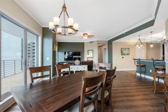 dining room featuring ornamental molding, wood-type flooring, and ceiling fan with notable chandelier