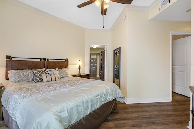 bedroom featuring dark hardwood / wood-style flooring, ceiling fan, and crown molding