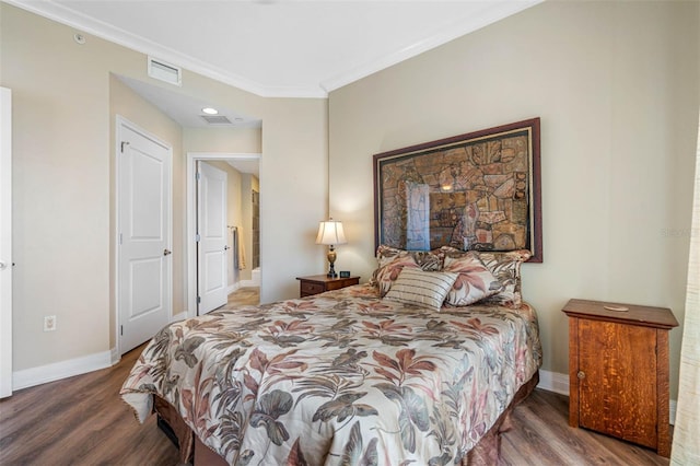 bedroom featuring ornamental molding and dark hardwood / wood-style floors